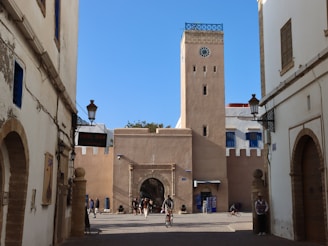 A moroccan landmark with arches and a clock tower.