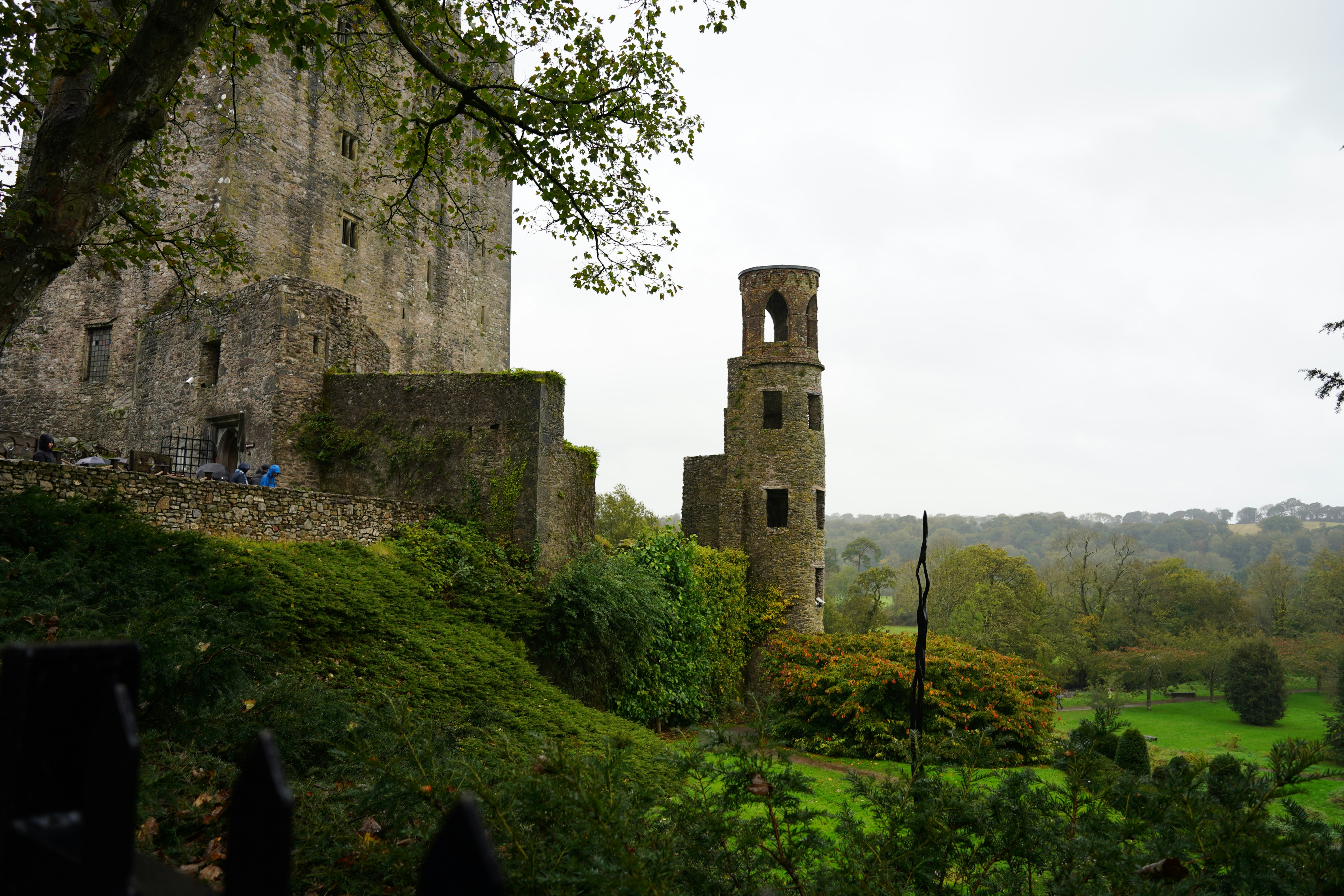 An old stone castle sits on a grassy hill.