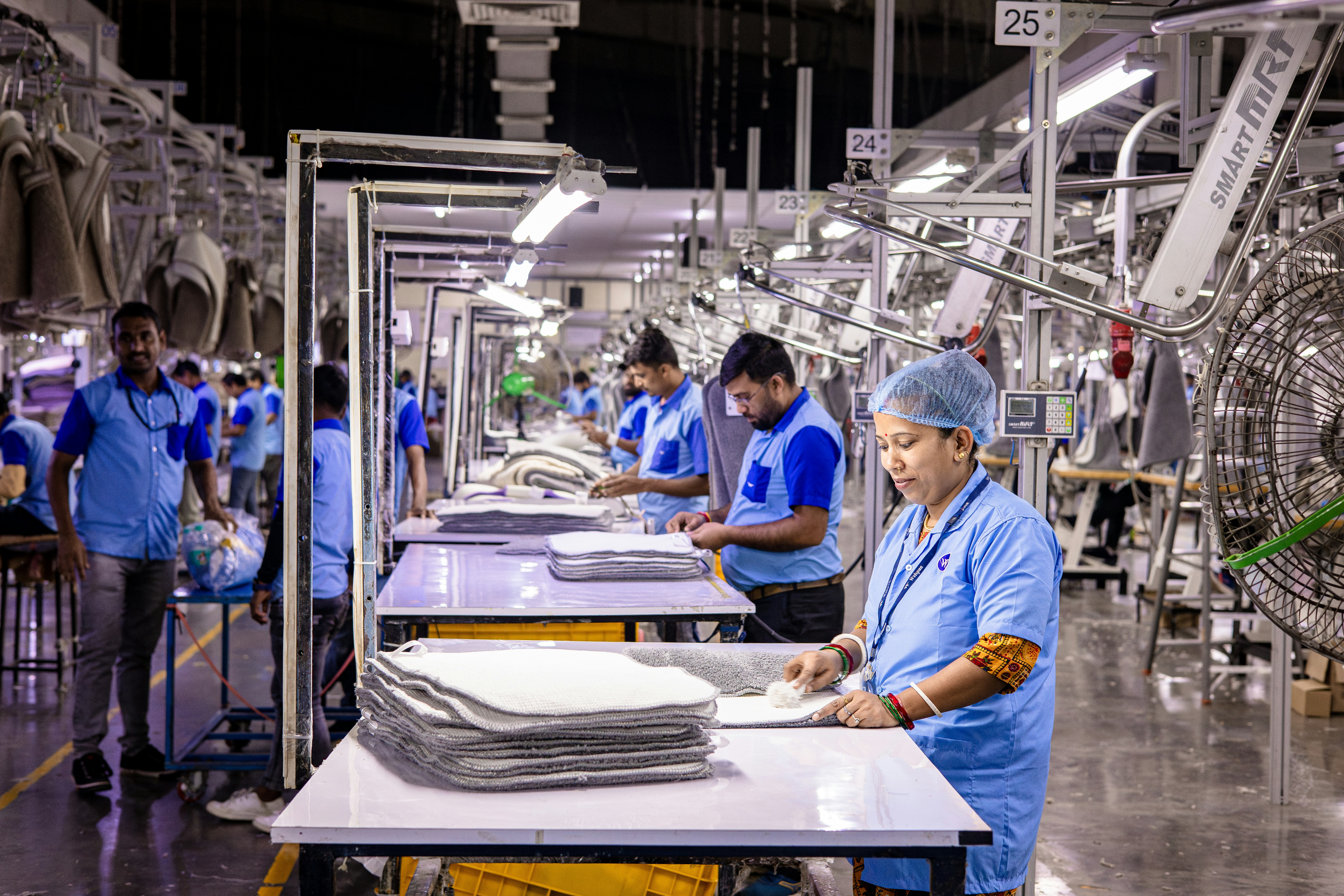 Workers are busy in an industrial garment factory.