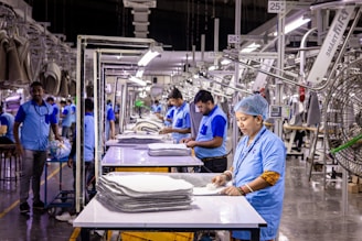 Workers are busy in an industrial garment factory.
