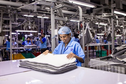 Workers are busy in an industrial clothing factory.