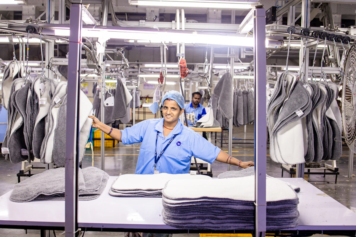 Workers processing textiles in a manufacturing plant