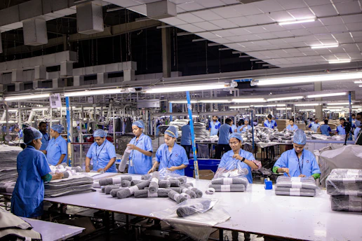 Workers are at an industrial clothing factory.