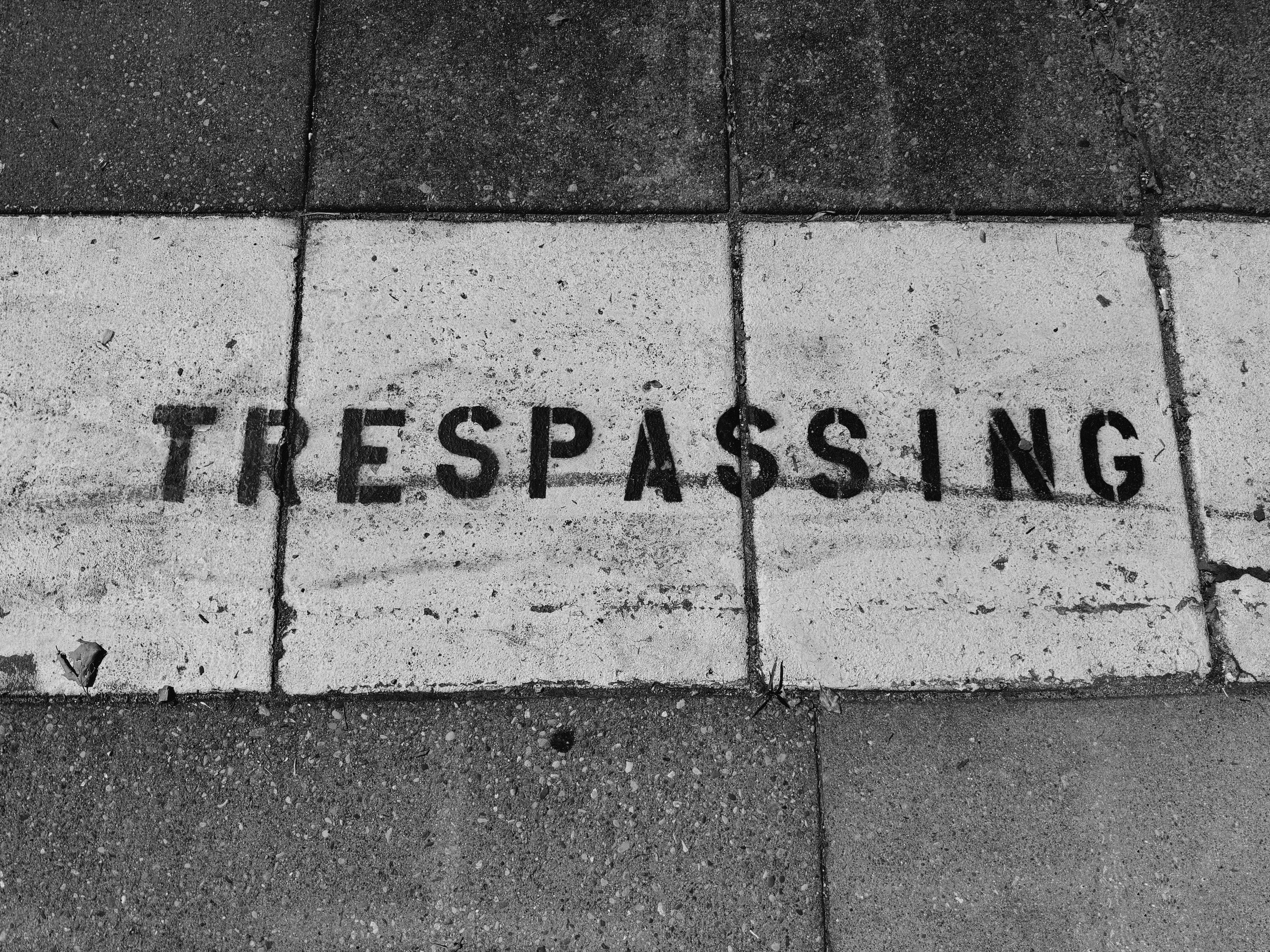 Trespassing is written on the tiles.