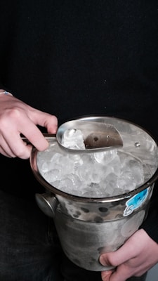 Someone is scooping ice from a bucket.