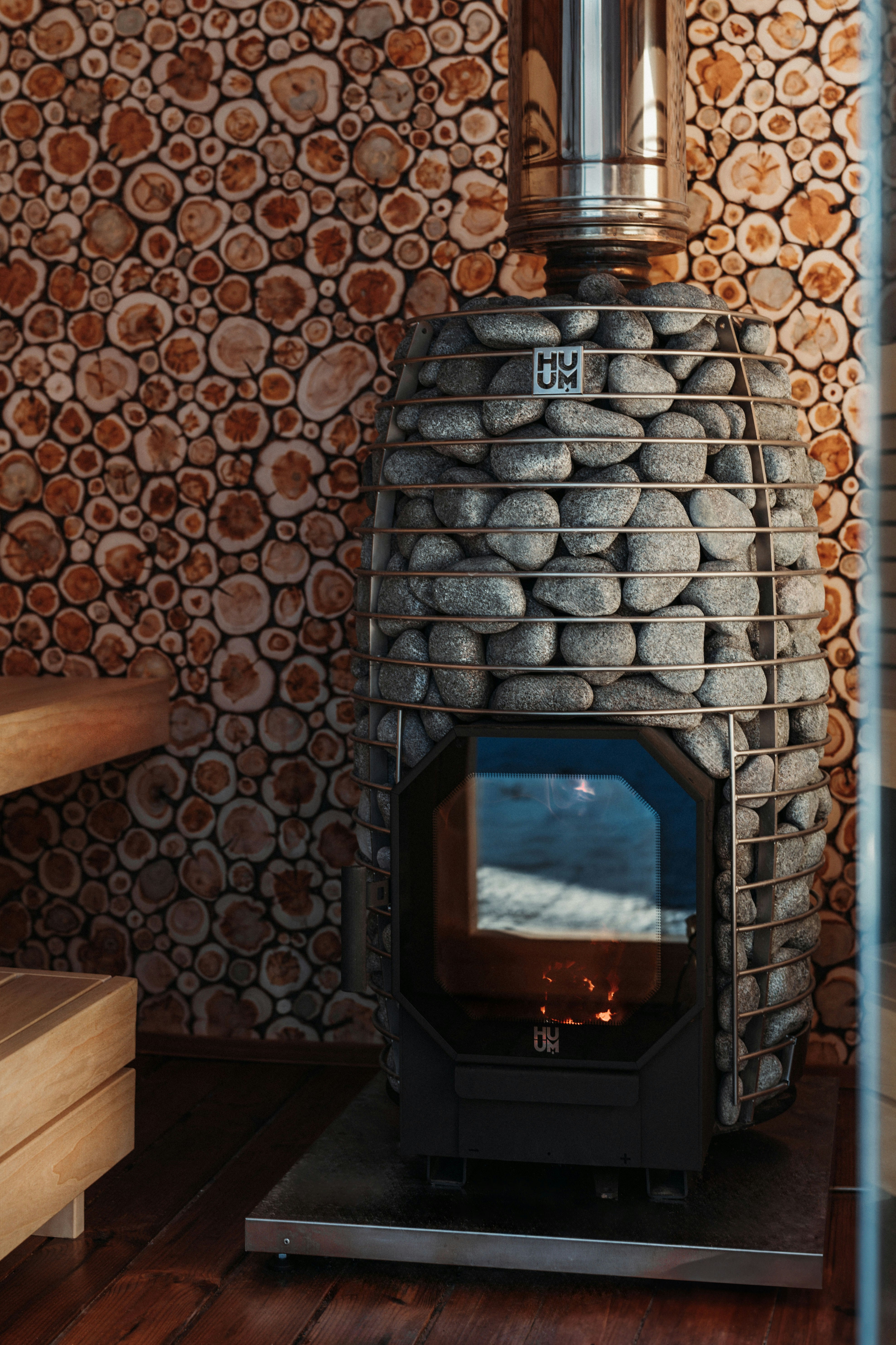 A stone sauna heater with burning flames.