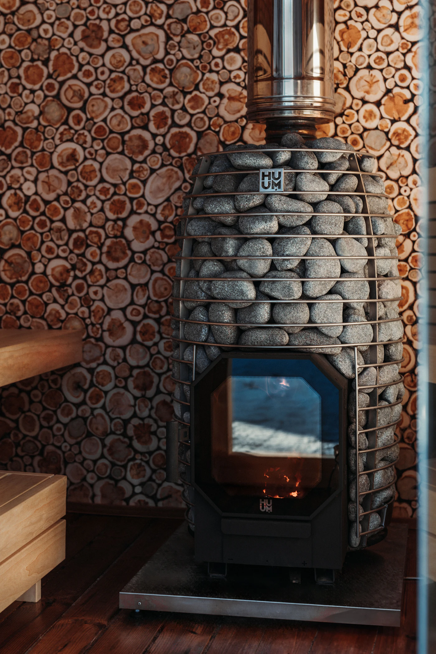 Wood-burning sauna heater with stones and visible fire