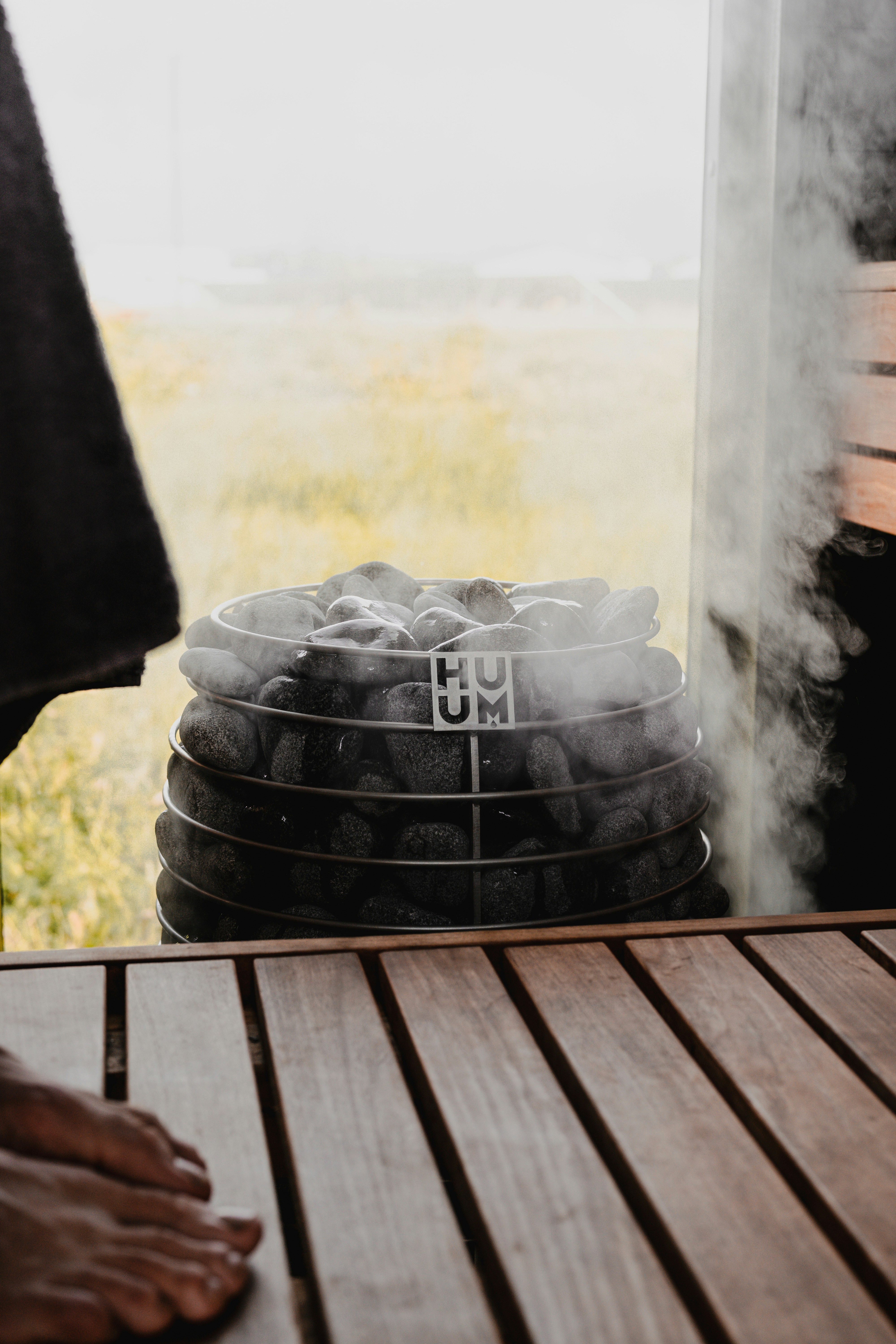 A steamy sauna with hot rocks and a view.