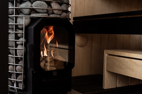 A wood-burning stove heats a sauna.