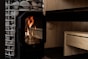 A wood-burning stove heats a sauna.