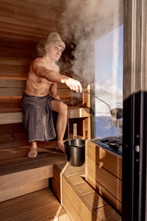 Man enjoys the heat and steam of a sauna.