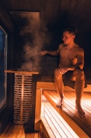 Man enjoys a steamy sauna experience.