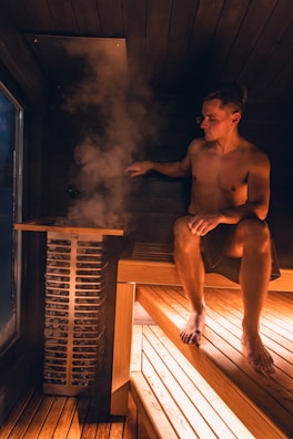Man enjoys a steamy sauna experience.