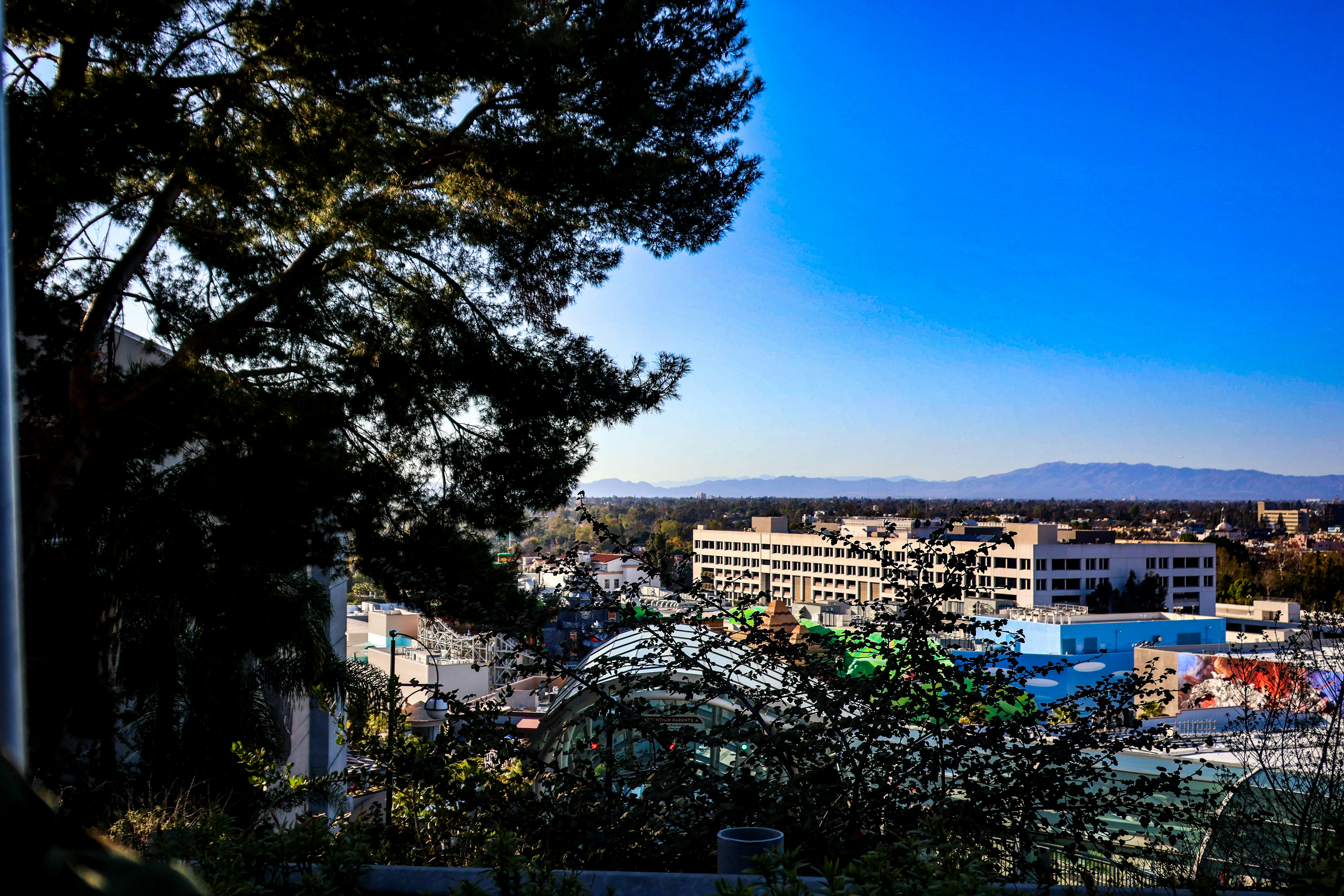 Cityscape view with buildings under a bright sky.