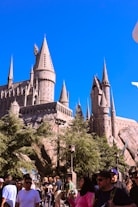 Hogwarts castle towers over a crowd.