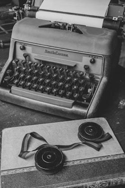 An antique typewriter sits with its ribbon.