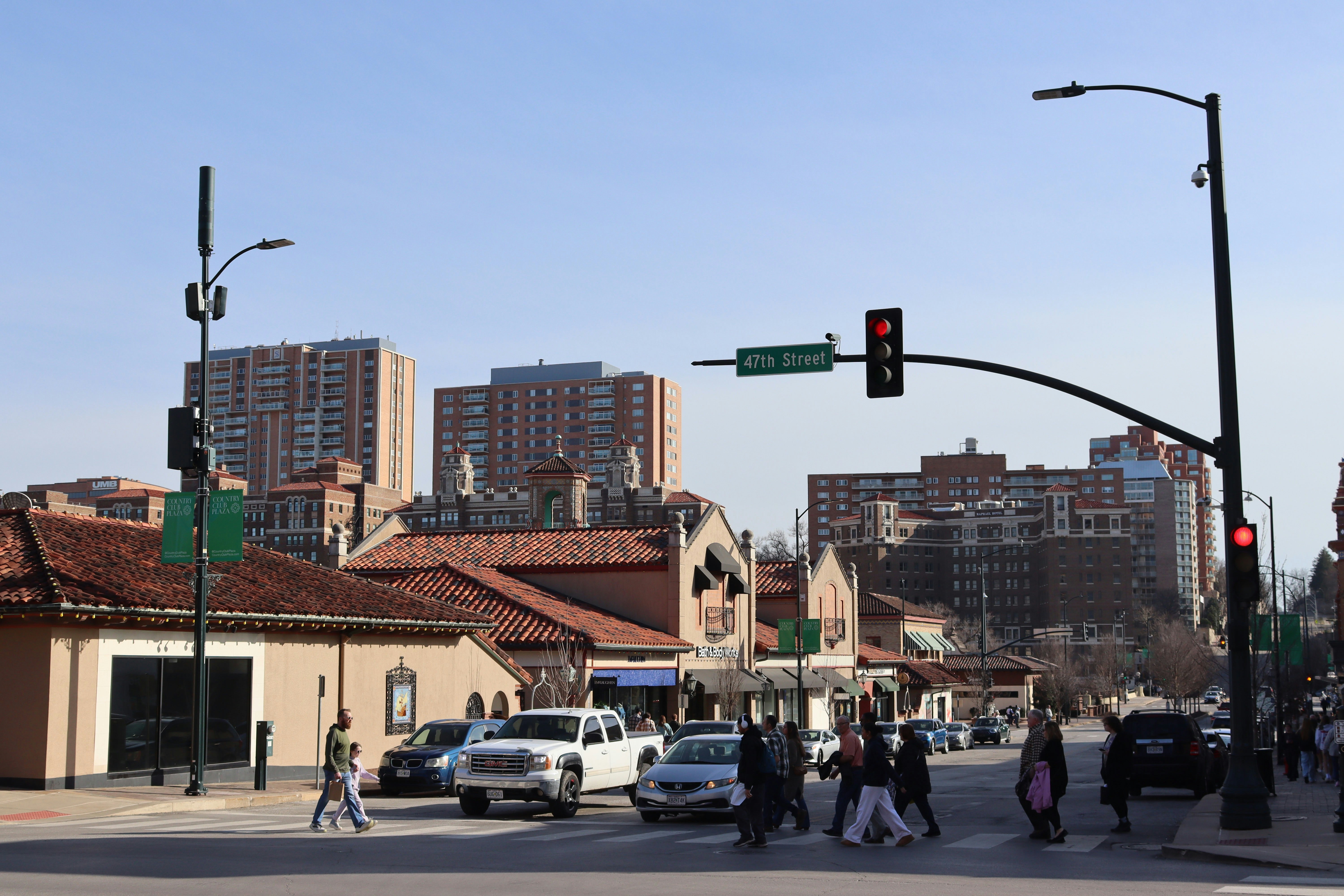 Busy city intersection with cars and pedestrians.