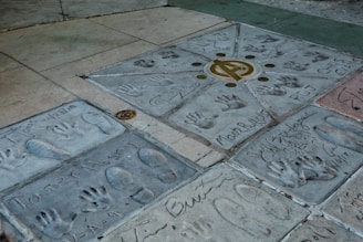 Celebrity handprints and footprints are embedded in the ground.