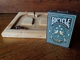 A cribbage board and bicycle playing cards are displayed.