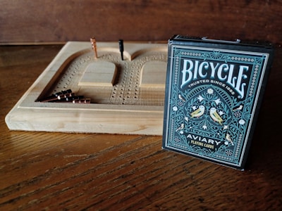 A cribbage board and bicycle playing cards are displayed.