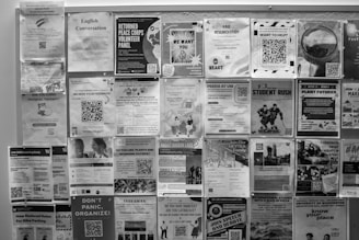 Bulletin board covered with many posters.