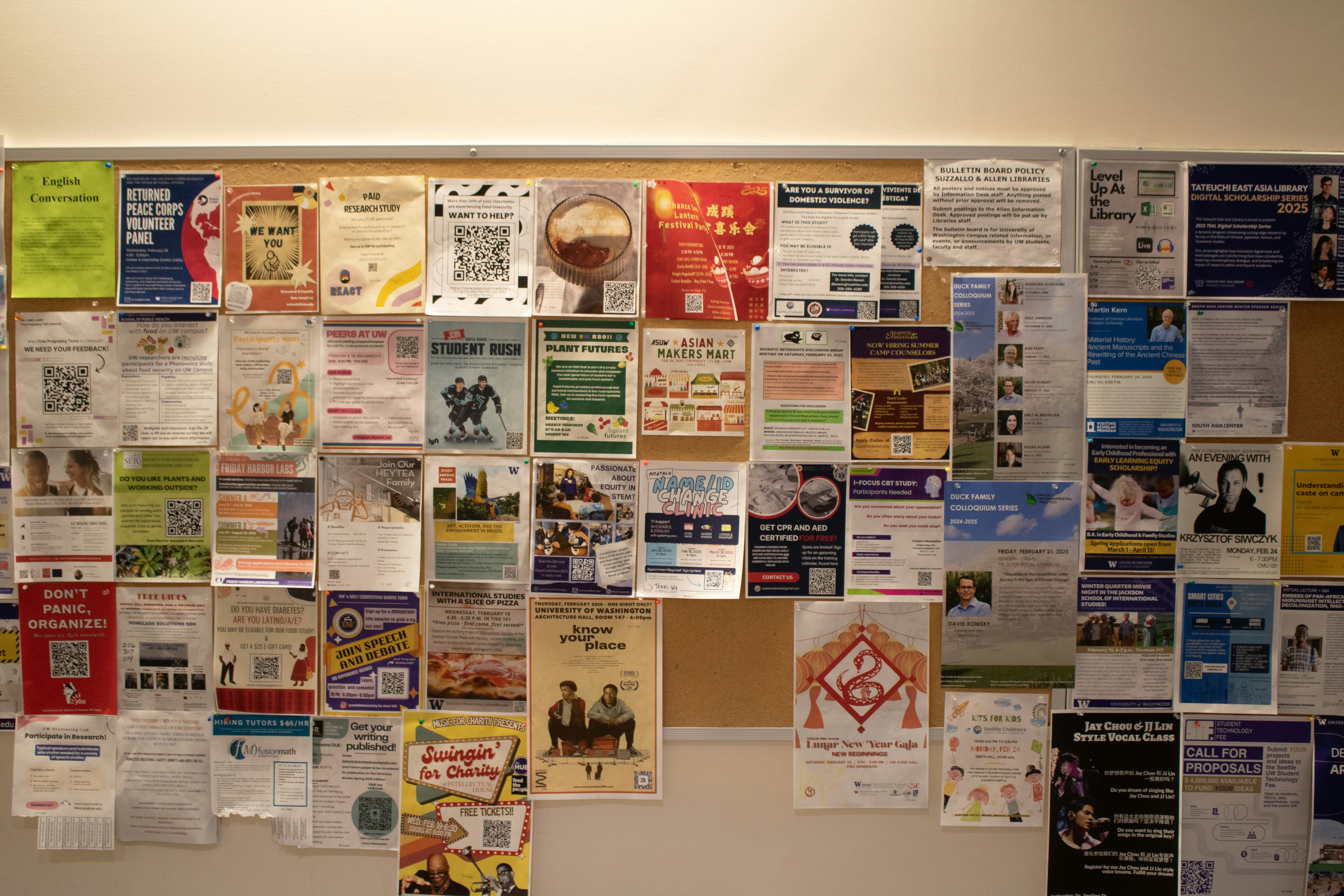 A bulletin board covered with various flyers.