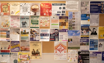 Bulletin board filled with various posters and flyers.