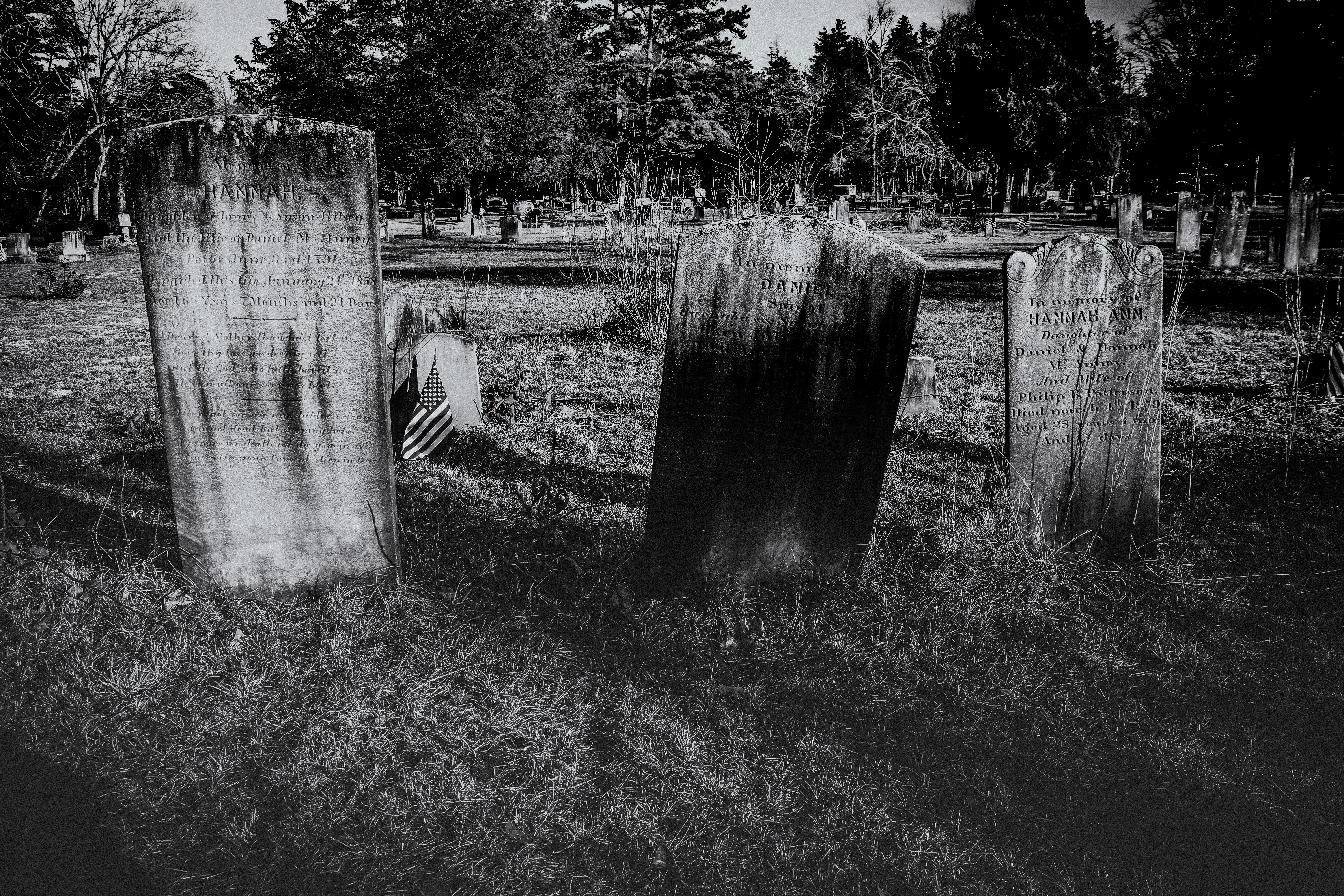 An old cemetery with leaning, weathered tombstones.