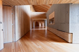 A wooden hallway with a modern, minimalist design.