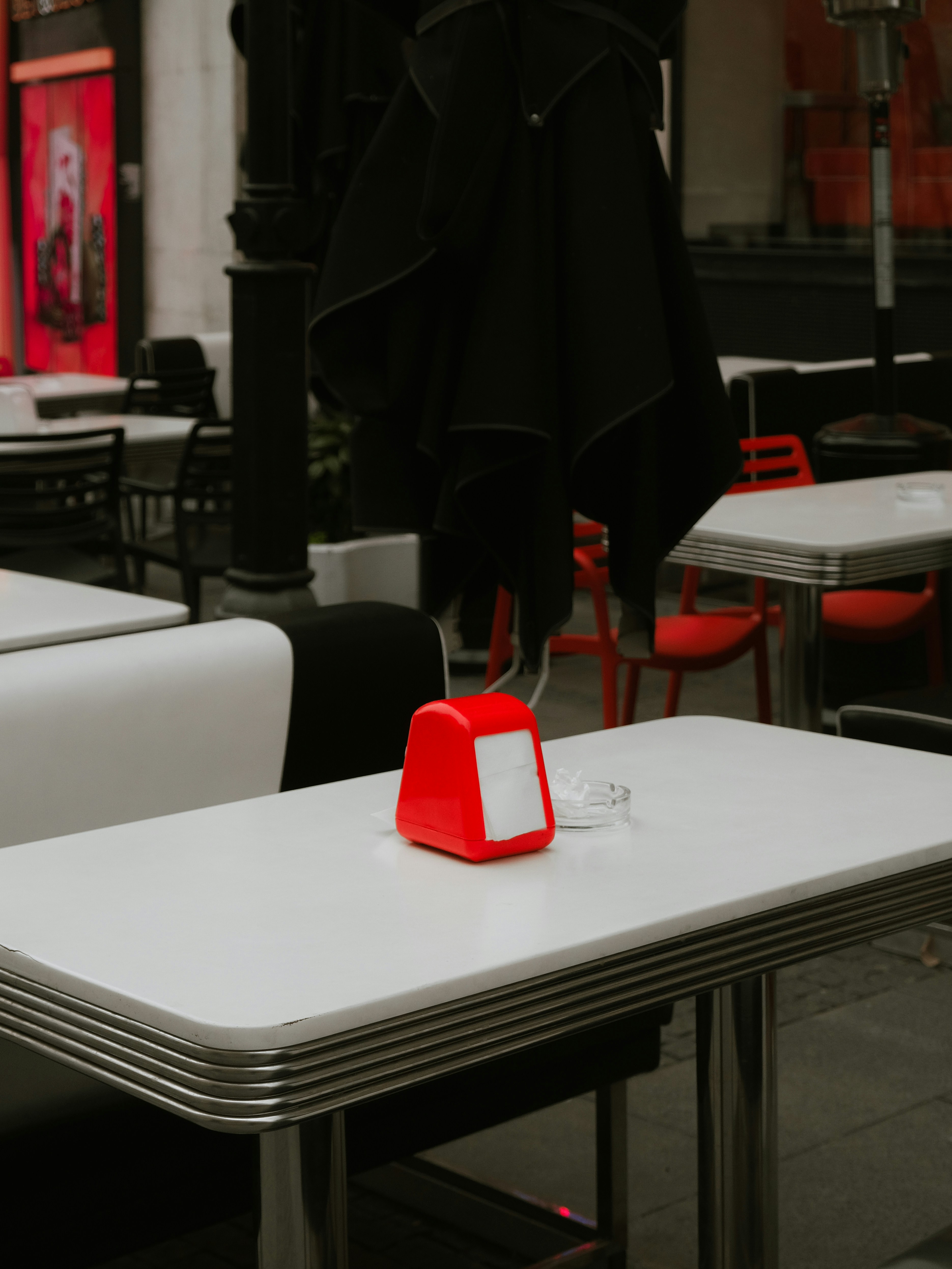 Empty tables and chairs outside a restaurant.