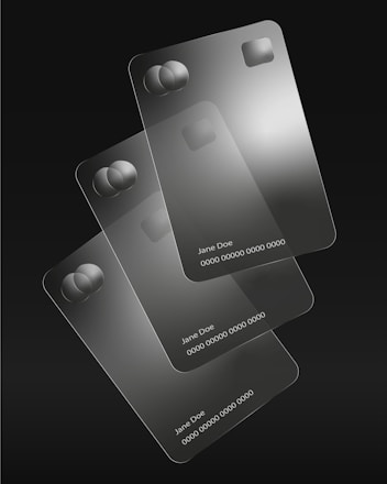Three transparent credit cards are stacked.