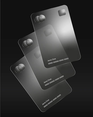 Three transparent credit cards are stacked