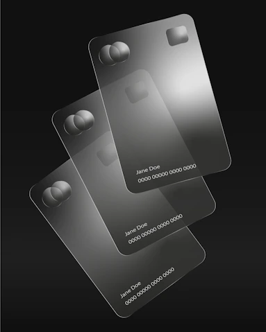 Three transparent credit cards are stacked