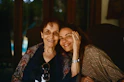 Mother and daughter share a loving embrace and smiles.