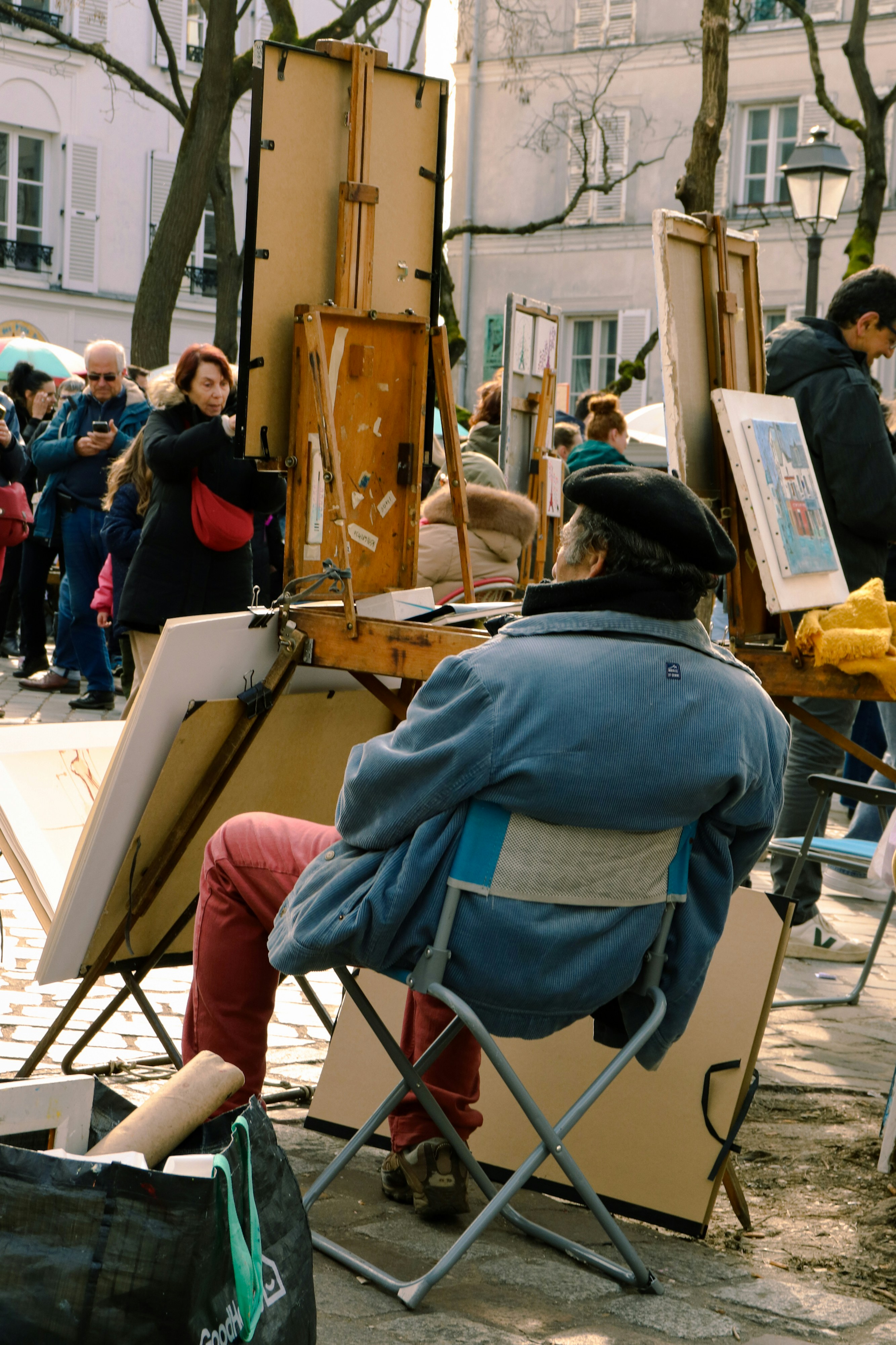 Artist paints outdoors in a european city.