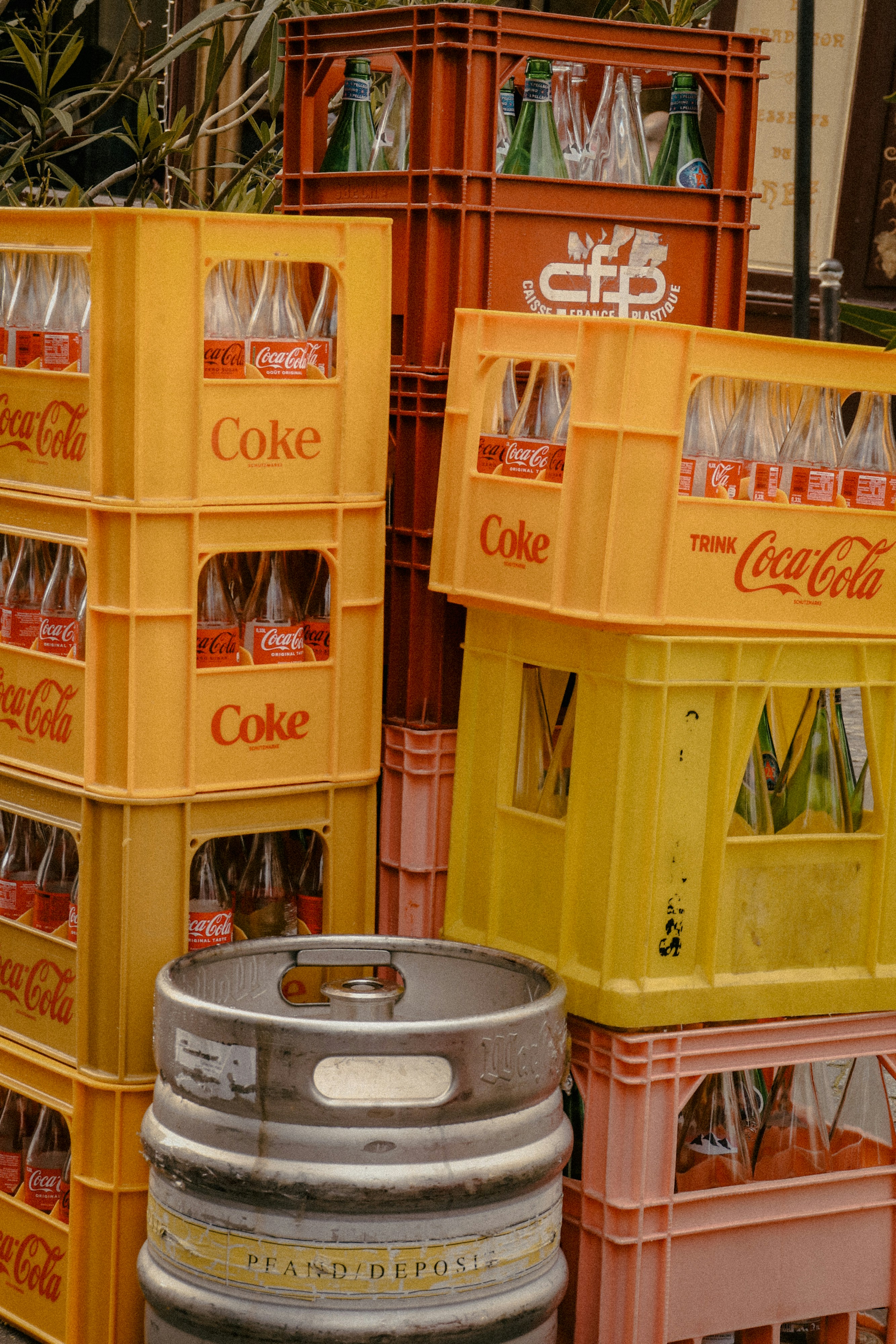 Coke crates and a keg are stacked.