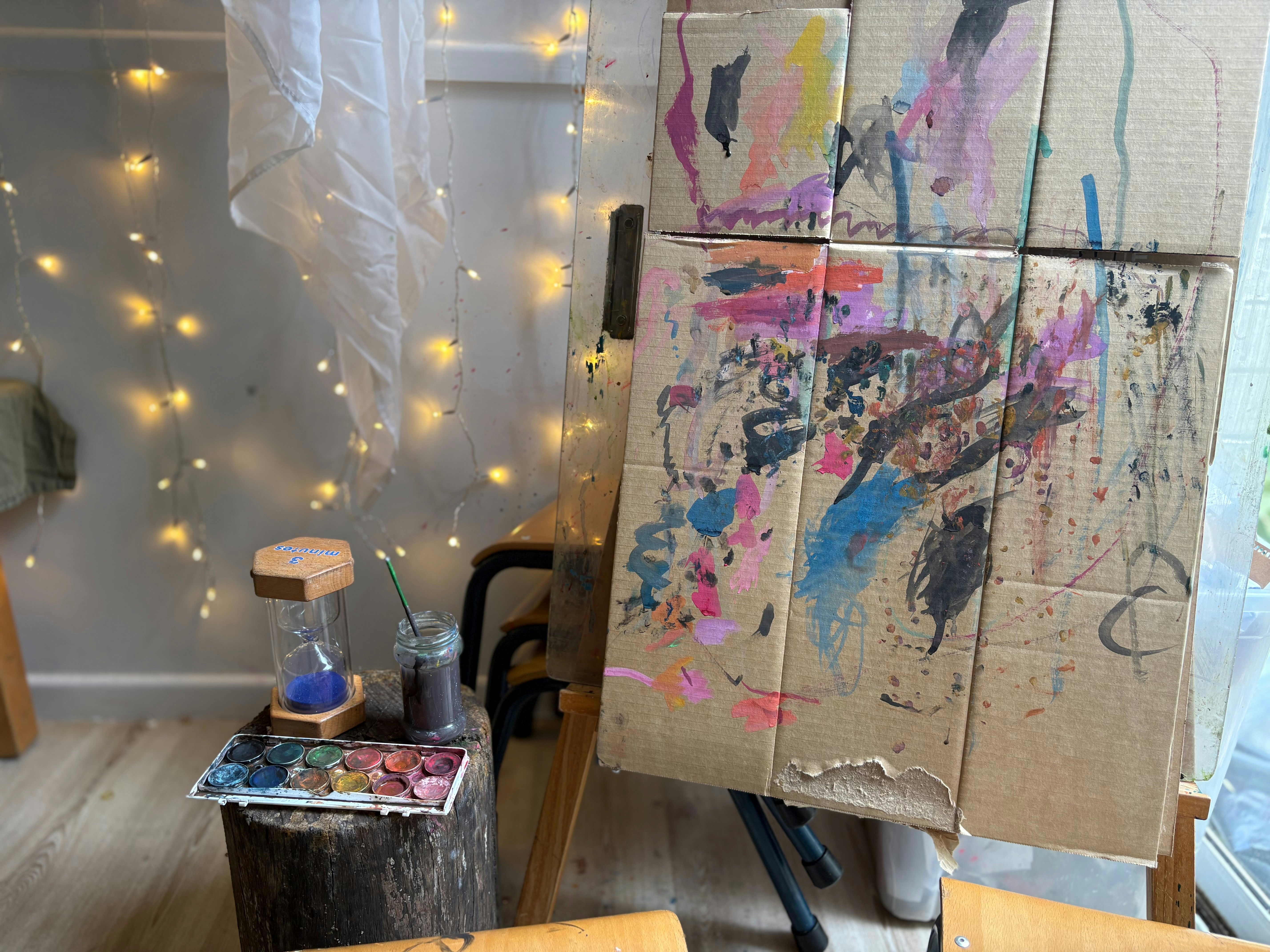 Messy easel with colorful paint splatters