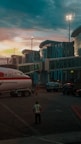 Airport scene at dusk, a plane parked.