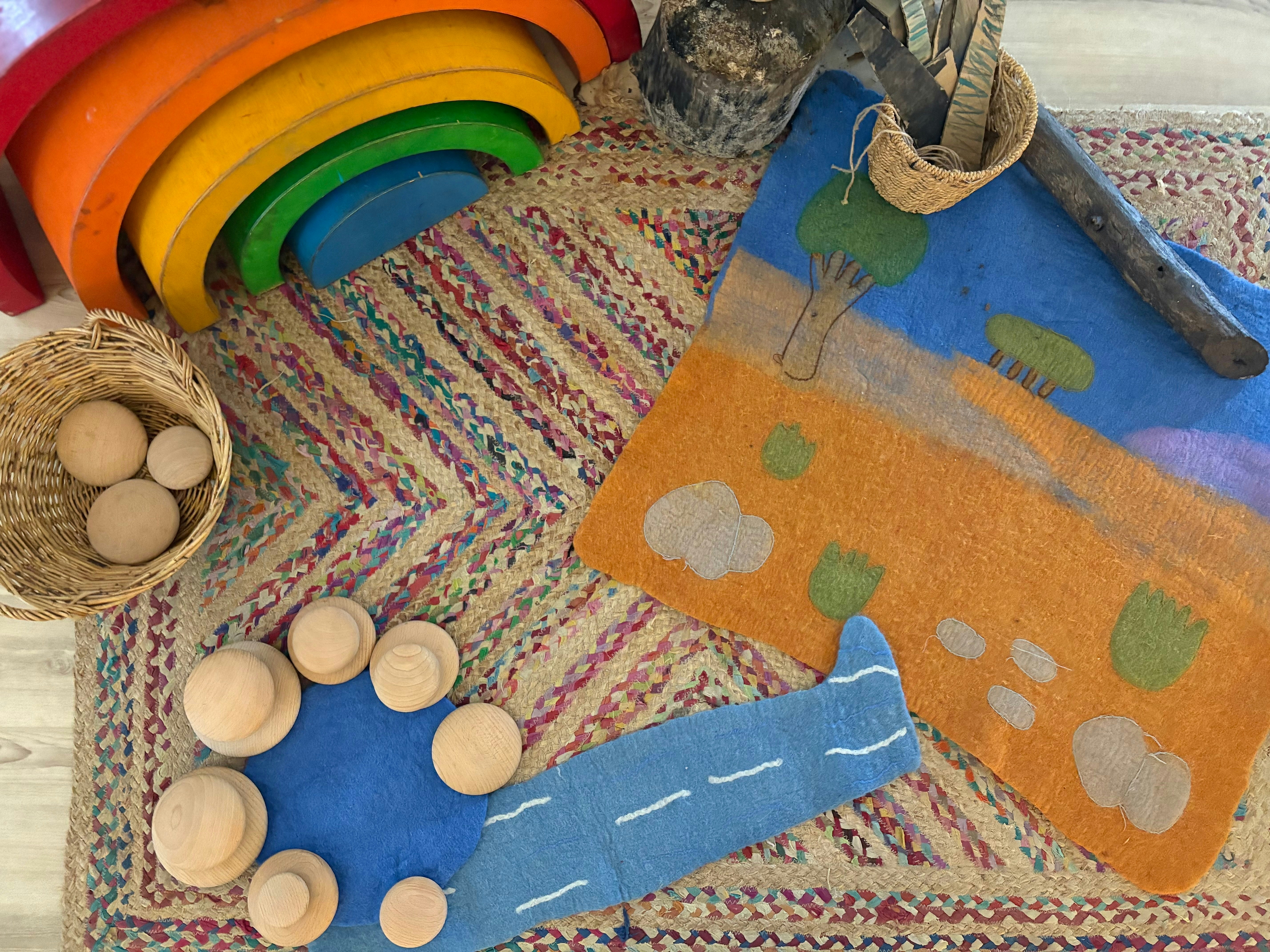 Colorful wooden toys and rugs arranged for preschool activities