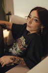 A young woman poses in a comfortable chair.