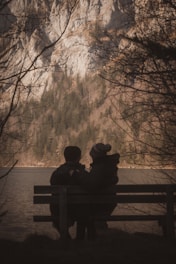 Couple enjoys the scenic view by a lake.