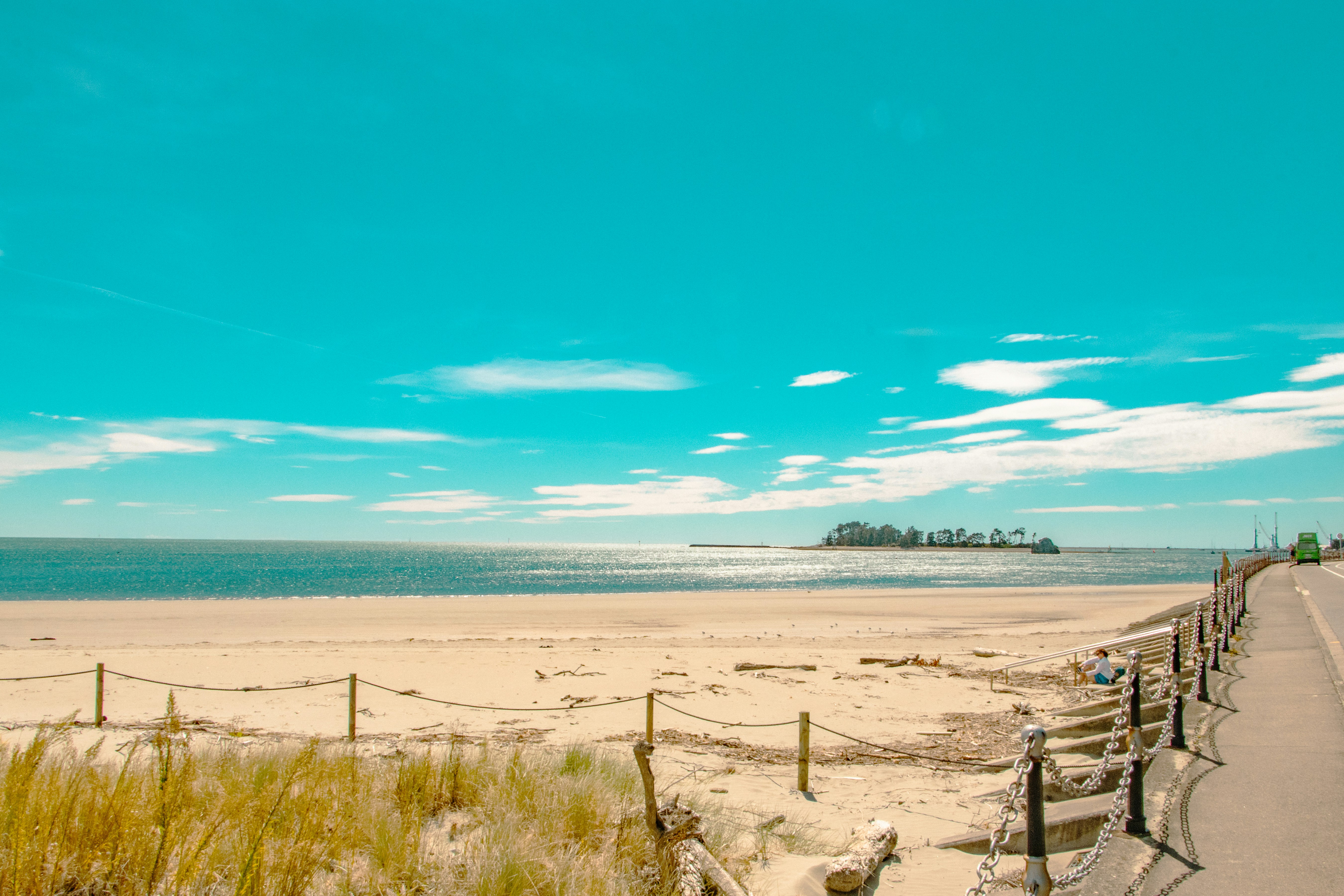 The beach displays a blue sky and calm waters.