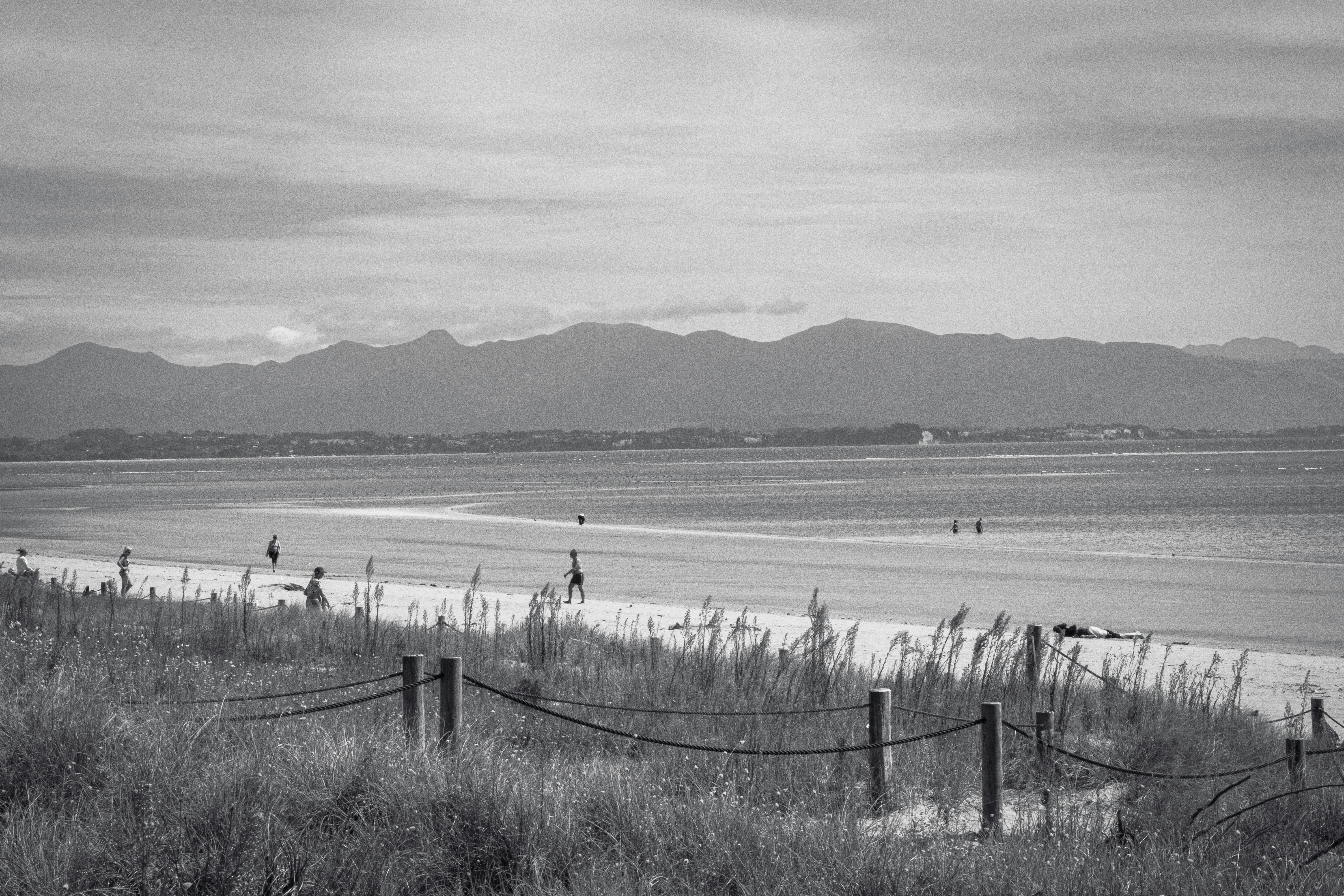 Beach scene with mountains in the distance.
