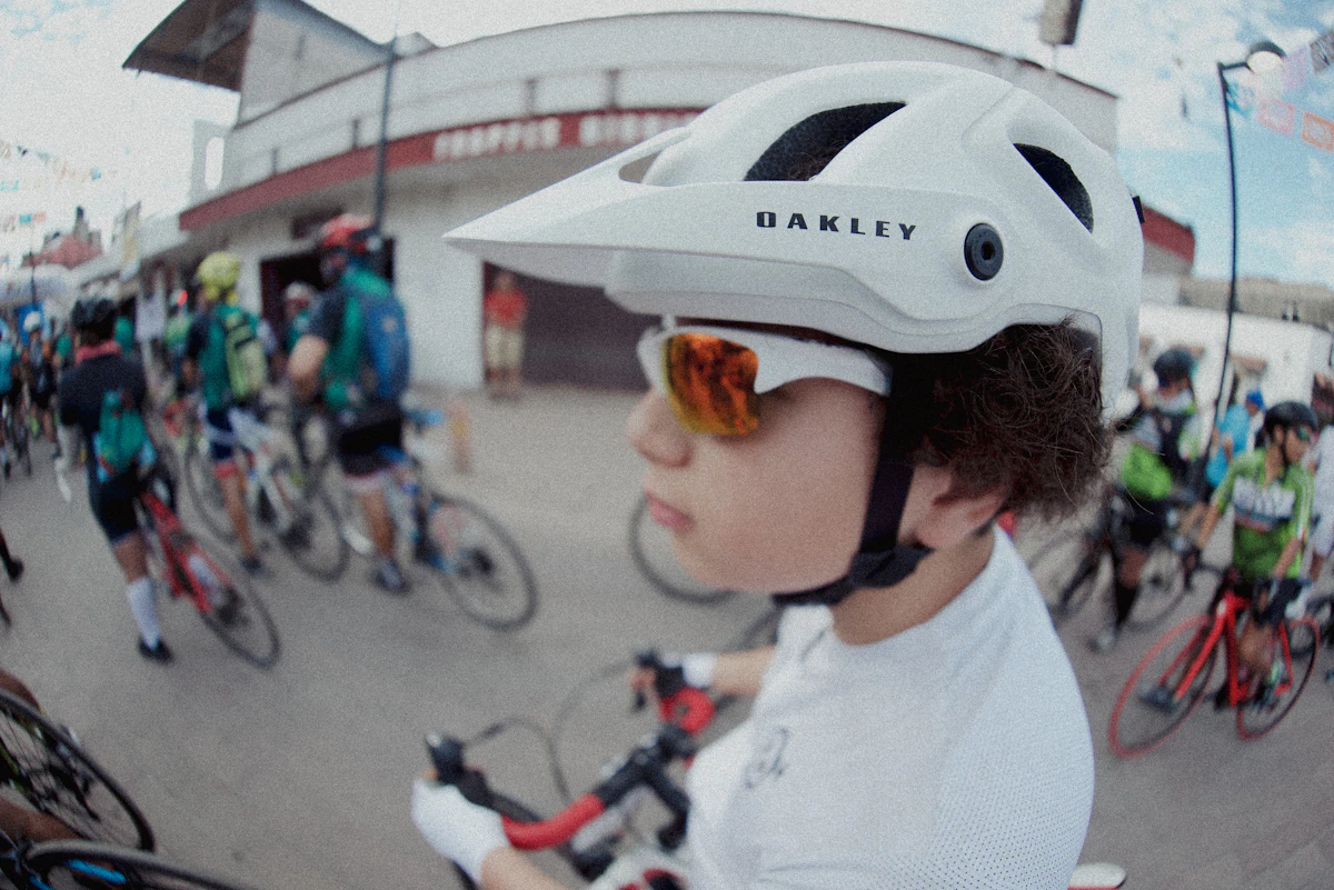Cyclist ready to race, surrounded by fellow riders.