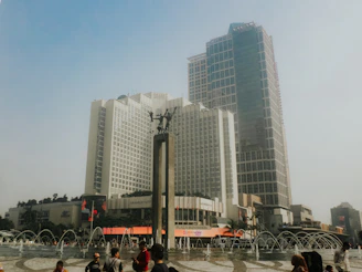 Modern buildings stand tall in a city square.