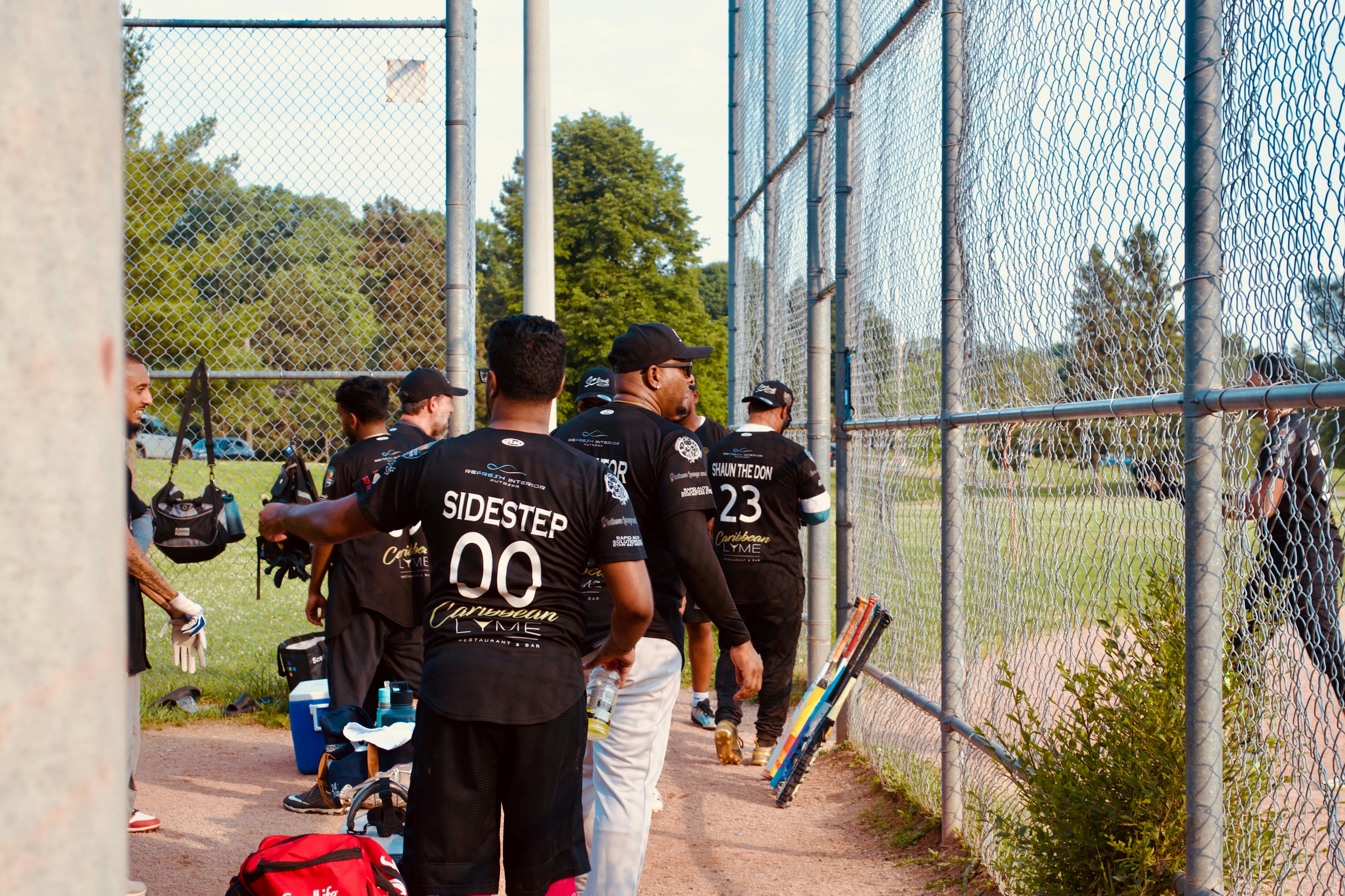 A baseball team stands near the field.