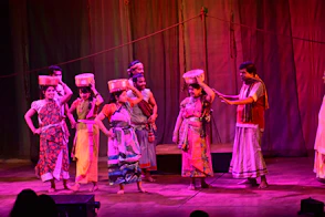 A group of people performing on a stage.