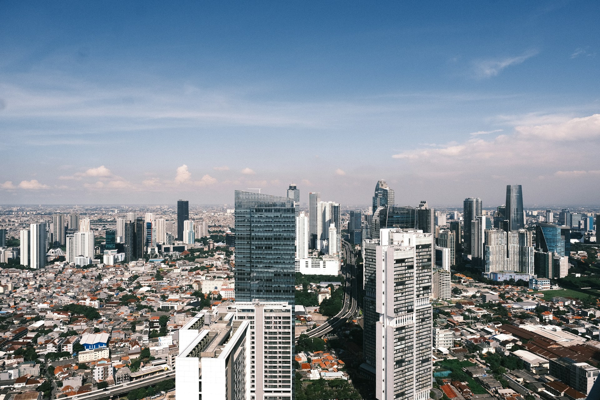 A dense city skyline under a clear, blue sky.