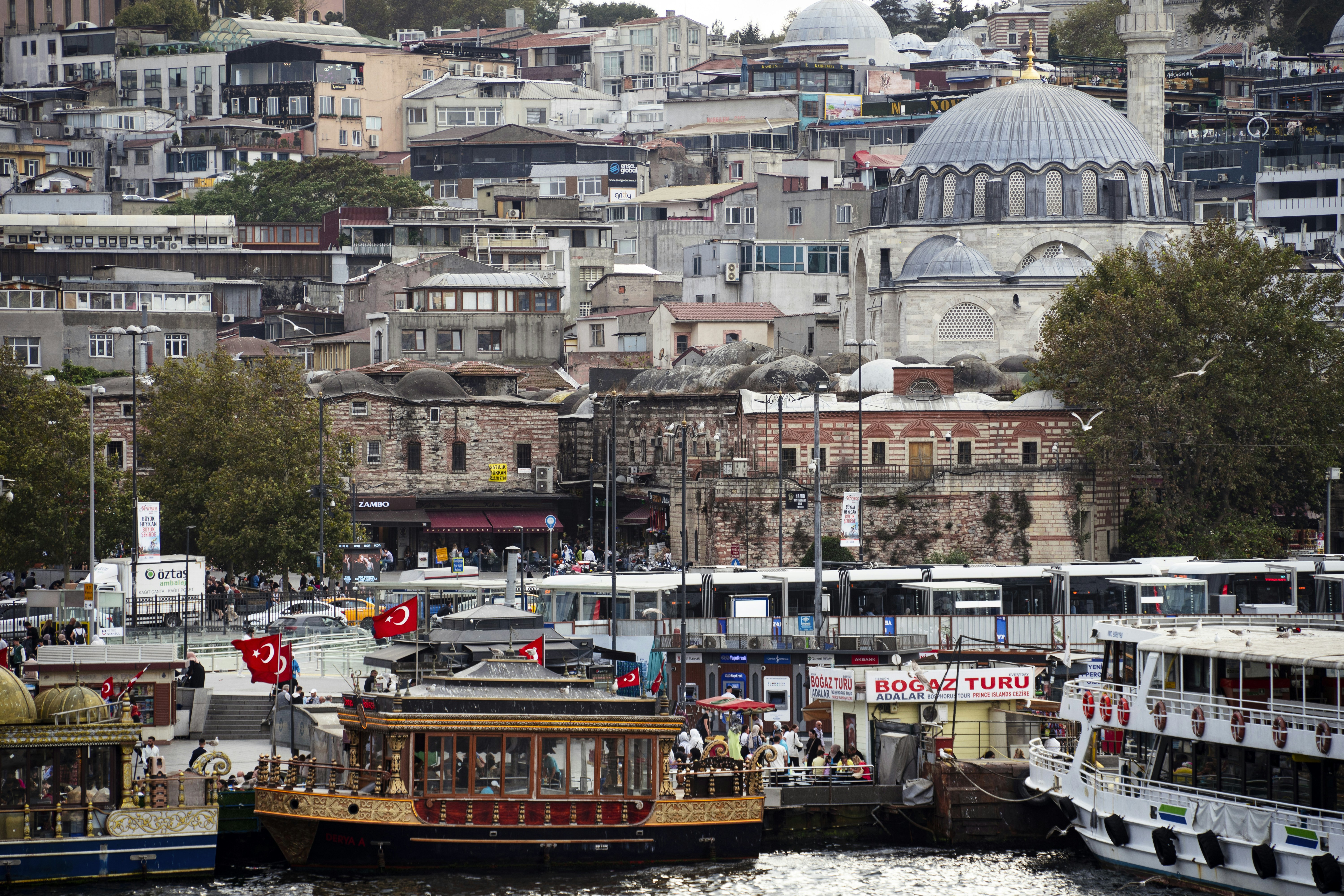 Istanbul cityscape with boats and a mosque.