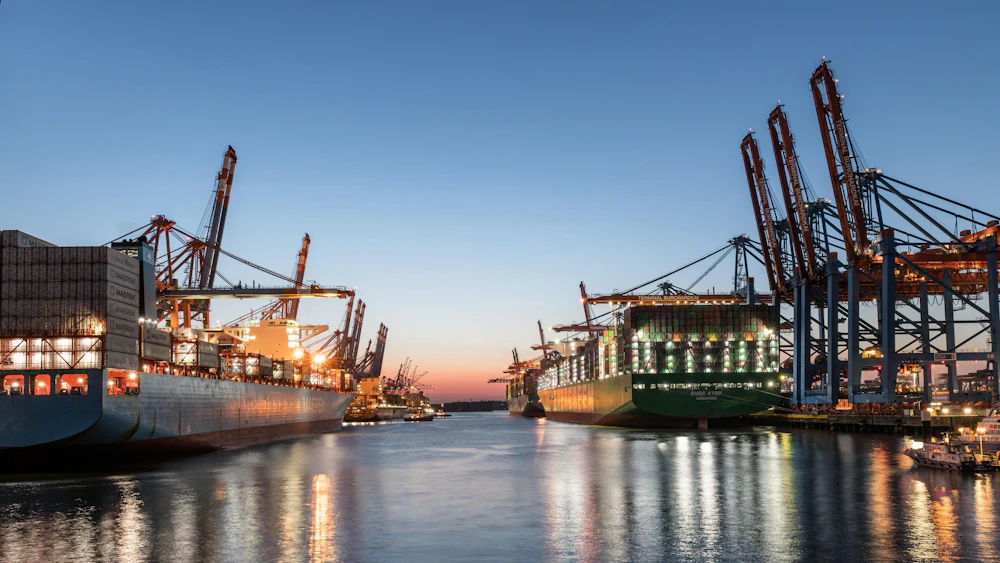 Port terminal at work, representing AJ Shipping Services' operational reliability